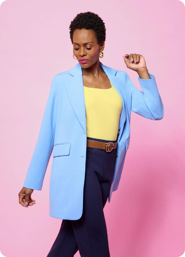 Model wearing jeans and powder blue suit jacket