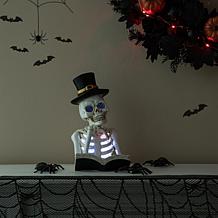 Glitzhome 10.25in. H Halloween Lighted Resin Skull Book Table Decor