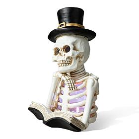 Glitzhome 10.25in. H Halloween Lighted Resin Skull Book Table Decor